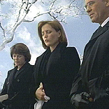 Scully�s mother stands to her right. Skinner to her left.